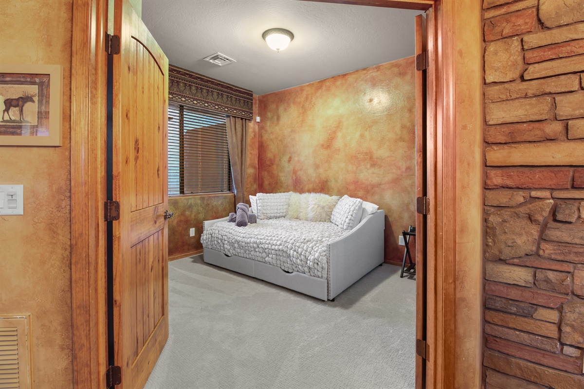 The second guest room includes full-size day bed