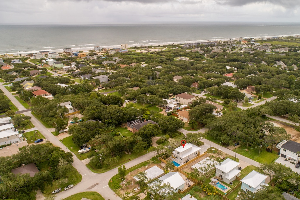 Here is the house in context, a handful of blocks back from a long, uncrowded stretch of sand. Close enough to walk in flip-flops, far enough that you sleep to crickets rather than traffic on the coast road.