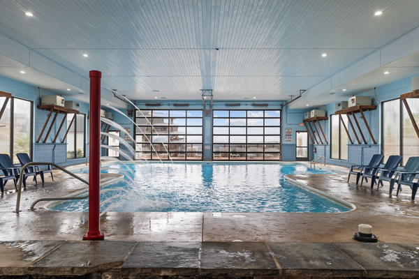 Indoor pool. Heated, and fun kid friendly features. Bathrooms, lounge chairs, and dining tables. Open year round.