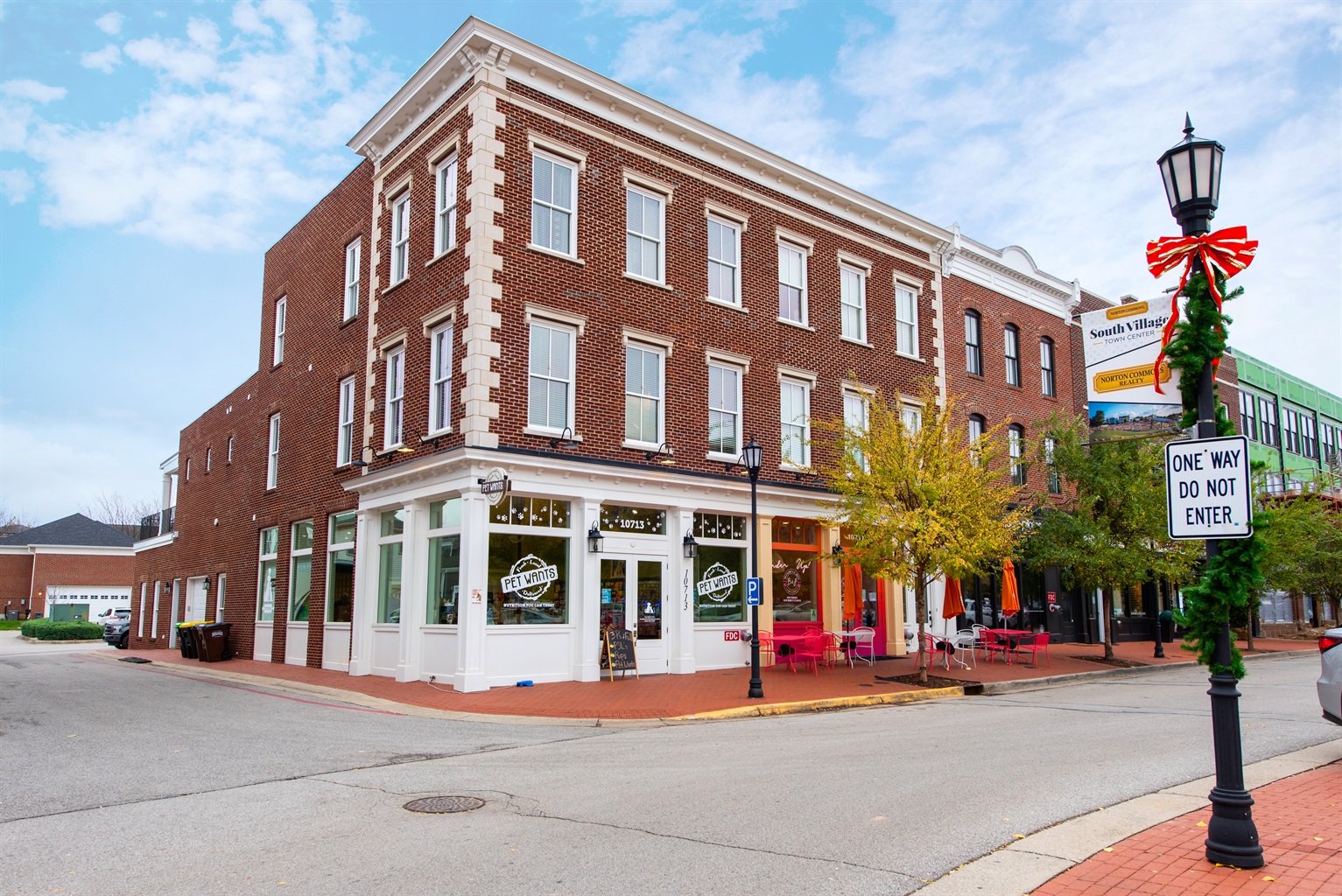 Situated in the heart of Norton Commons, this location captures the essence of community living with its charming red brick buildings, unique local shops, and festive street lamps. Enjoy a stunning corner view that perfectly blends modern convenience with 