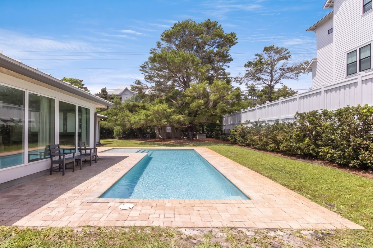 A striking stretch of blue defines the backyard, bringing understated elegance to the outdoor setting.