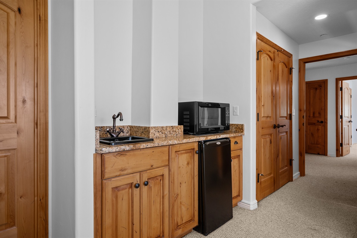 Includes a kitchenette with microwave and sink, ideal for added convenience and comfort.