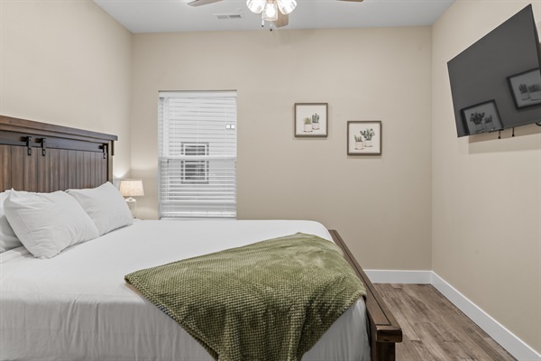 Bedroom #4 has a king size bed, TV, dresser and closet.