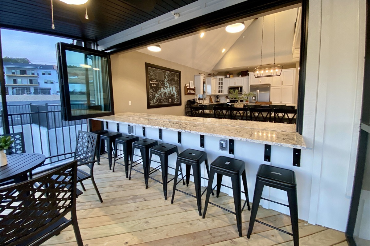 Main level screened in deck window ups up to dining area