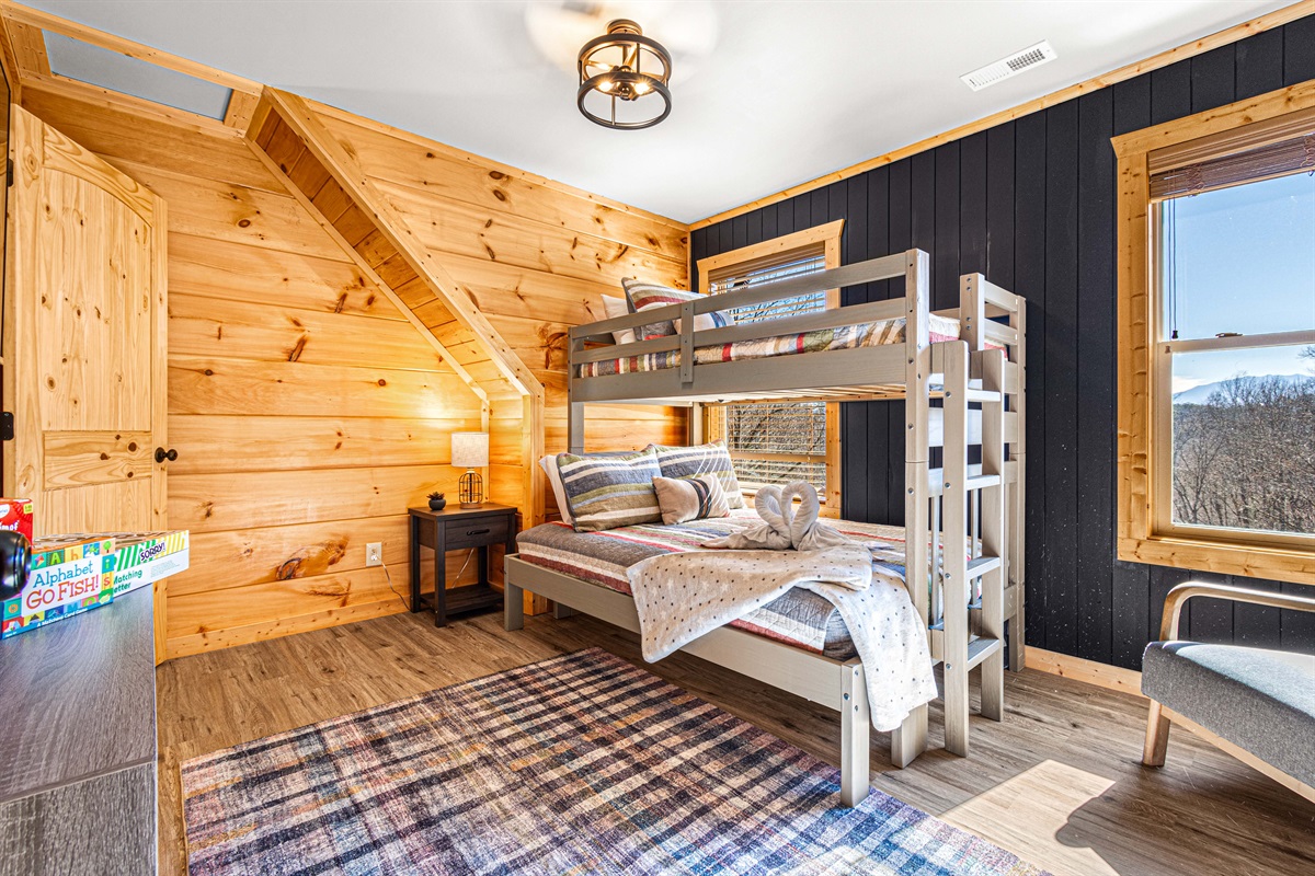 The bunk room offers TV, books, a reading chair and games and a view!.