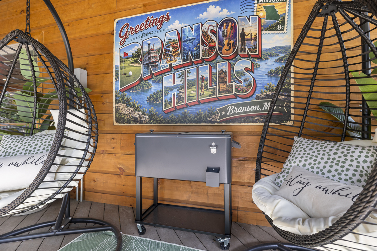 An egg chair, a drink fridge, and postcard art - the hangout corner.