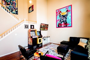 Ultimate Family Fun Zone! 🎮🛋️ – Our living room is all about relaxation, with plush couches, a TV for bonding, and an arcade for hours of gaming excitement!