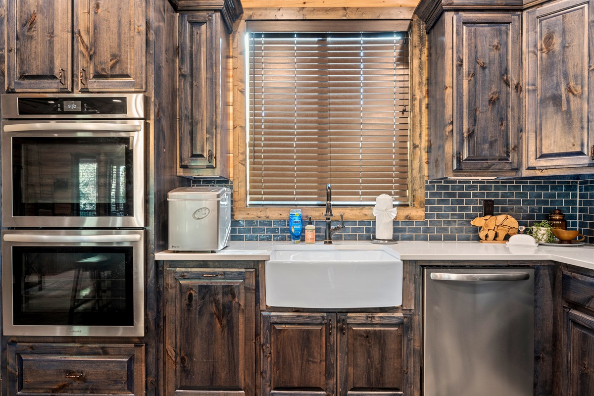 The kitchen combines rustic charm with modern conveniences, perfect for preparing meals after a day of outdoor fun.