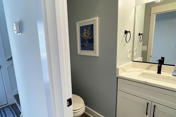 Stylish and easily accessible half bathroom, perfect for added convenience during your stay.