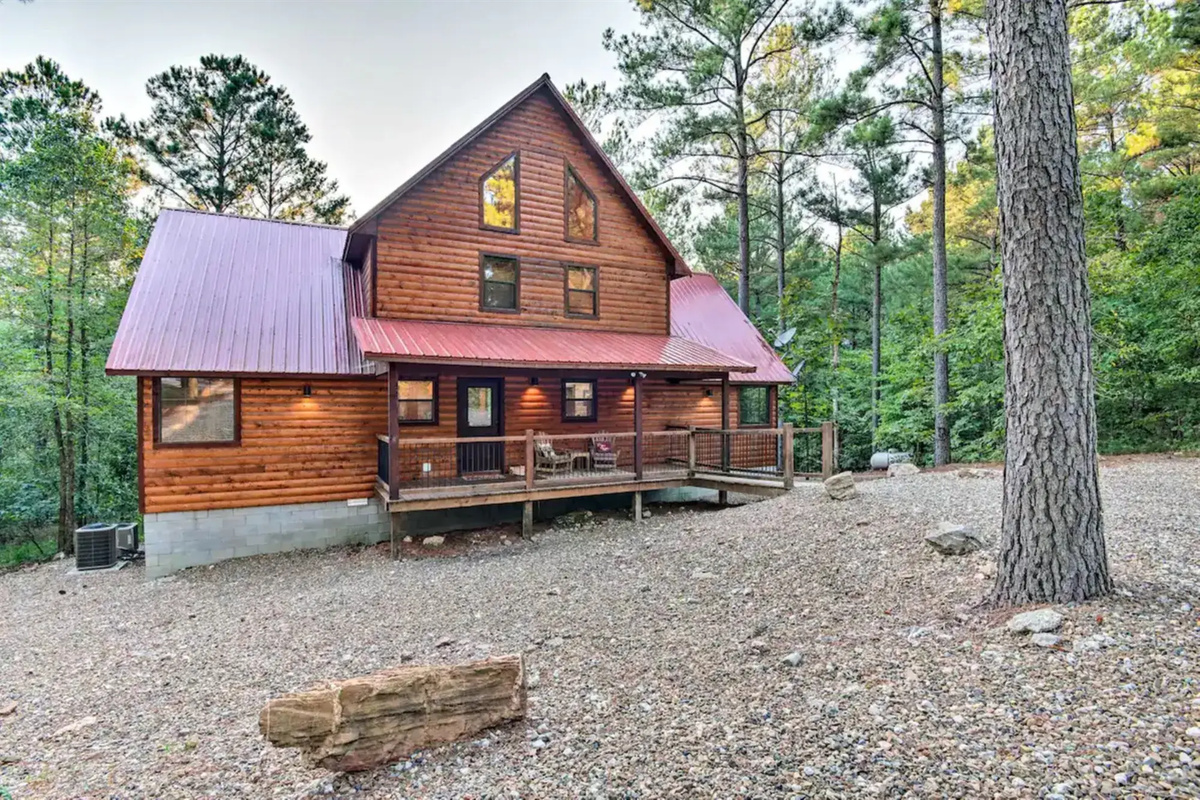 Exterior Retreat: Embrace nature on the expansive deck, surrounded by lush pine trees!