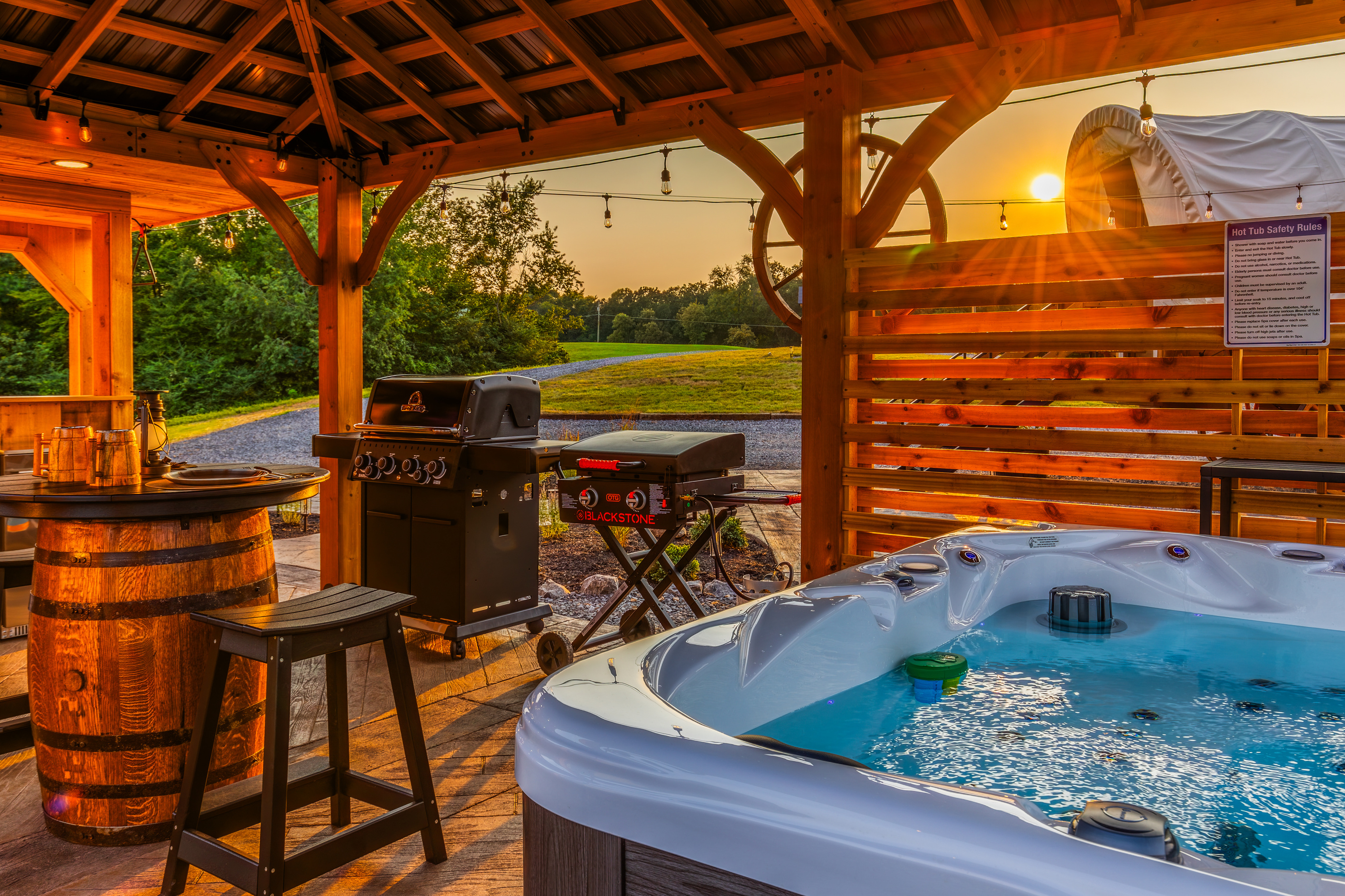 Sunset views from the hot tub pavilion with grill, Blackstone, and private outdoor dining.