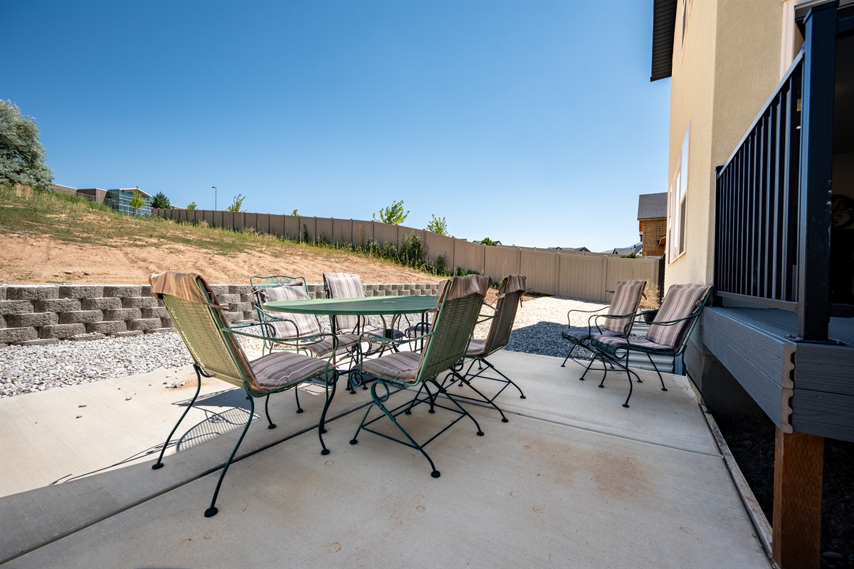 The main unit features a spacious private patio with a dining table and chairs for eight, offering a perfect spot to unwind or enjoy meals outdoors.