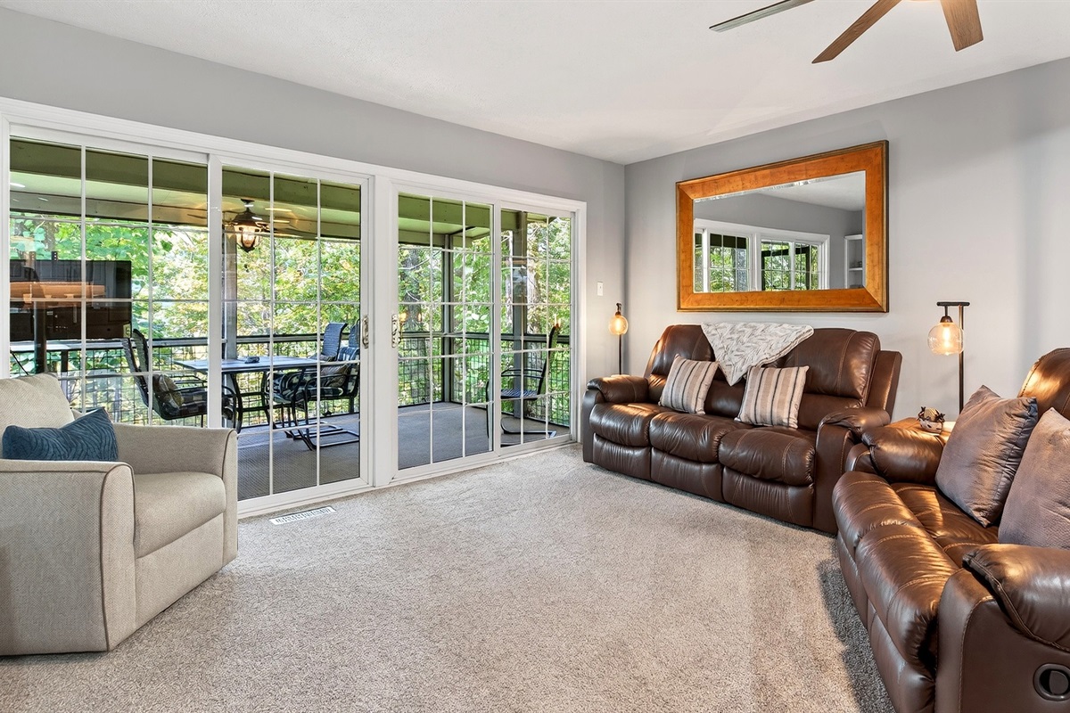 Main living area with doors leading to the deck.