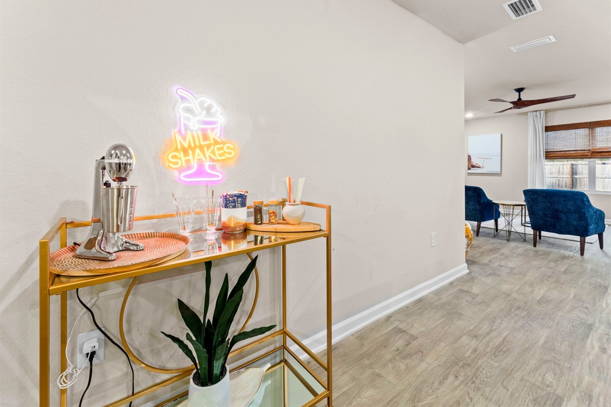 This stylish milkshake bar adds personality and charm while connecting the living and dining spaces seamlessly.
