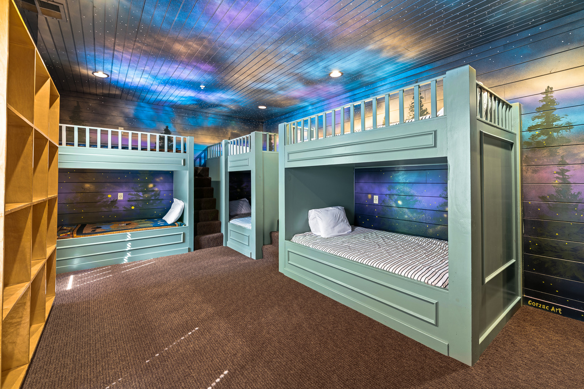 Sleep beneath the fireflies and stars as your kids camp in this immersive bunk room! 