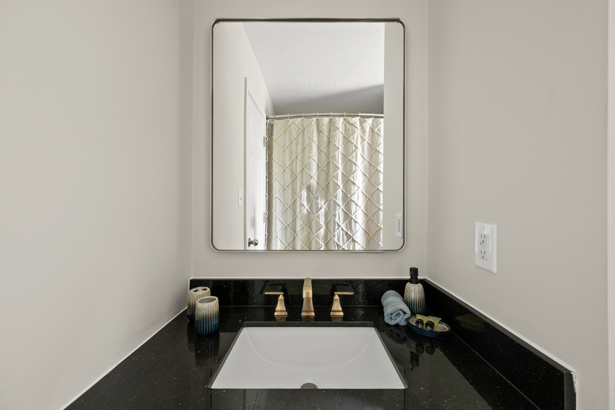 Bathroom 2 offers a convenient tub and shower combination along with a single vanity, providing plenty of space for guests to get ready for the day's adventures.