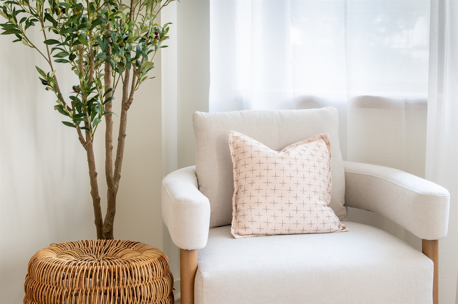 Cozy reading nook with soft armchair, natural light, and greenery
