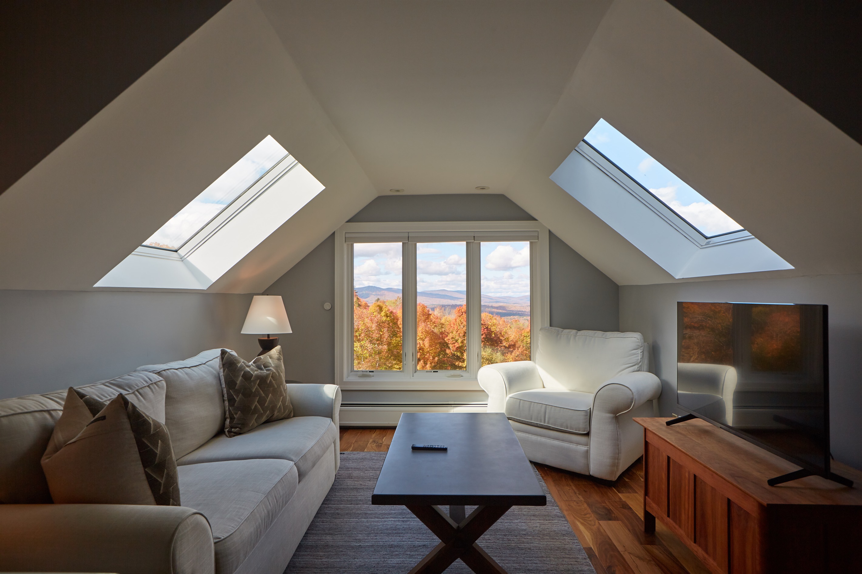 Cozy up in this inviting lounge to watch a movie or simply take in the vibrant seasonal views through the large picture windows.