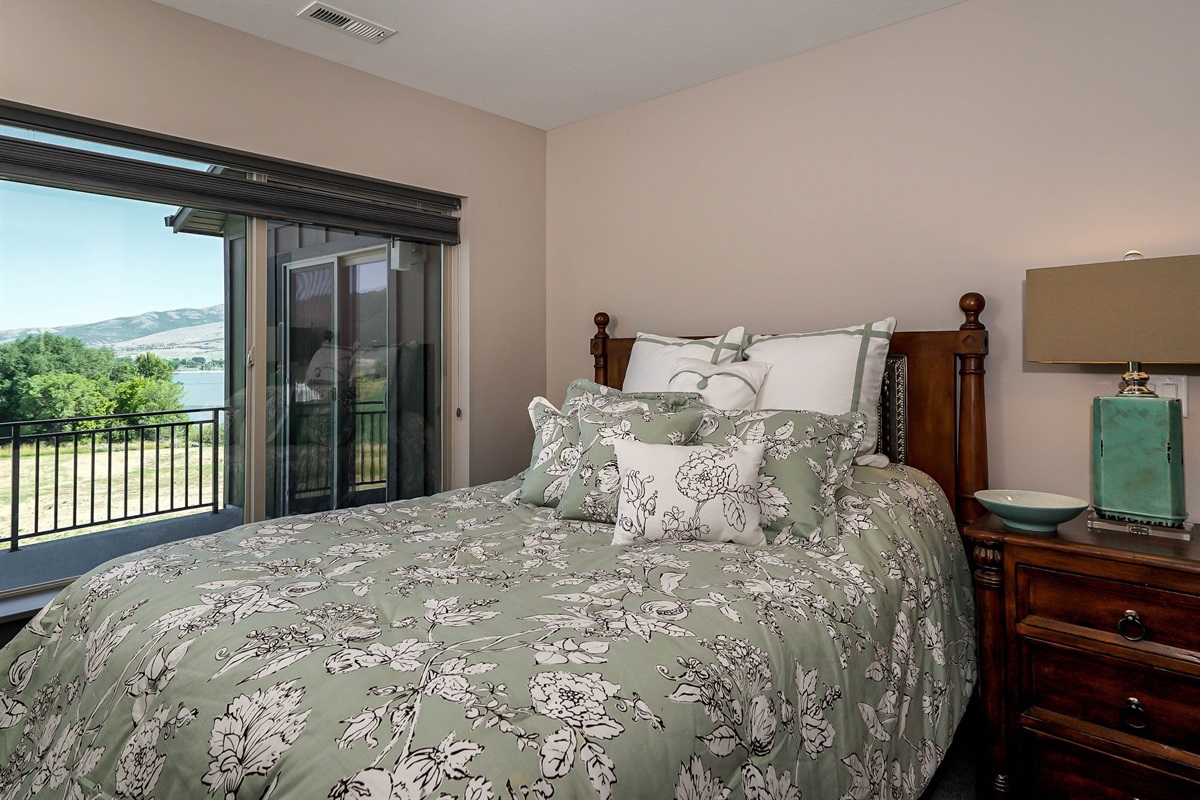 Upper-level queen bedroom with access to shared deck.