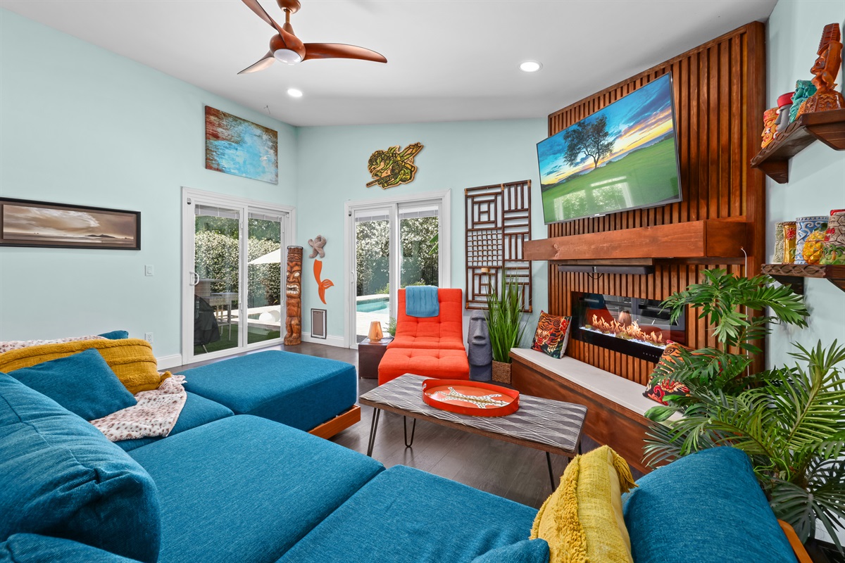 Comfortable living area with inviting seating and a pleasant pool vista, ideal for unwinding.