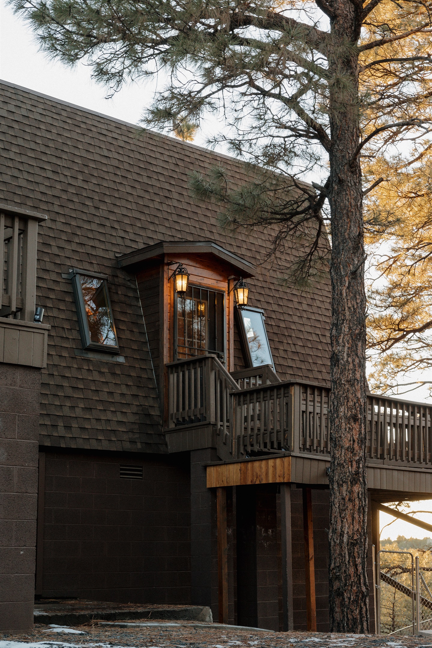 The charming entryway at Poppywood Pines welcomes guests with warm lighting and gothic western style. This unique Show Low A-frame nestled among towering ponderosa pines offers an unforgettable White Mountains vacation rental experience near hiking and fis