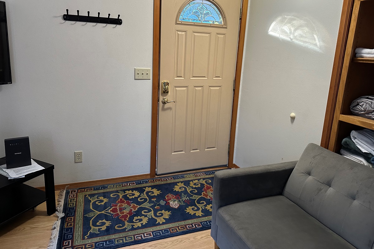 Relax in the cozy living area with a comfortable sofa.ng area