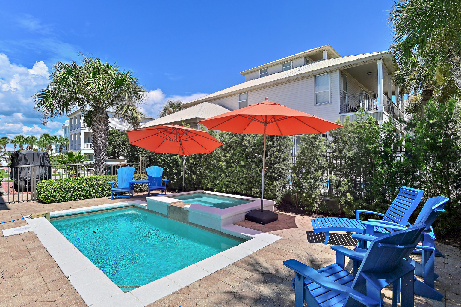 Enjoy sunny afternoons by the private pool and spa, surrounded by tropical palms and colorful coastal touches. The perfect place to relax, unwind, and make unforgettable 30A vacation memories.