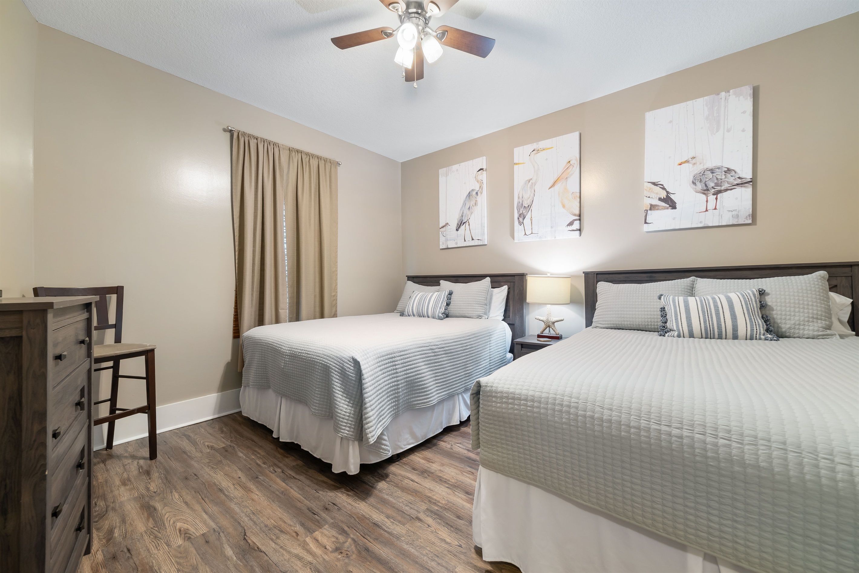 A versatile bedroom featuring two Queen beds, ideal for families or friends traveling together, with a comfortable and welcoming atmosphere.