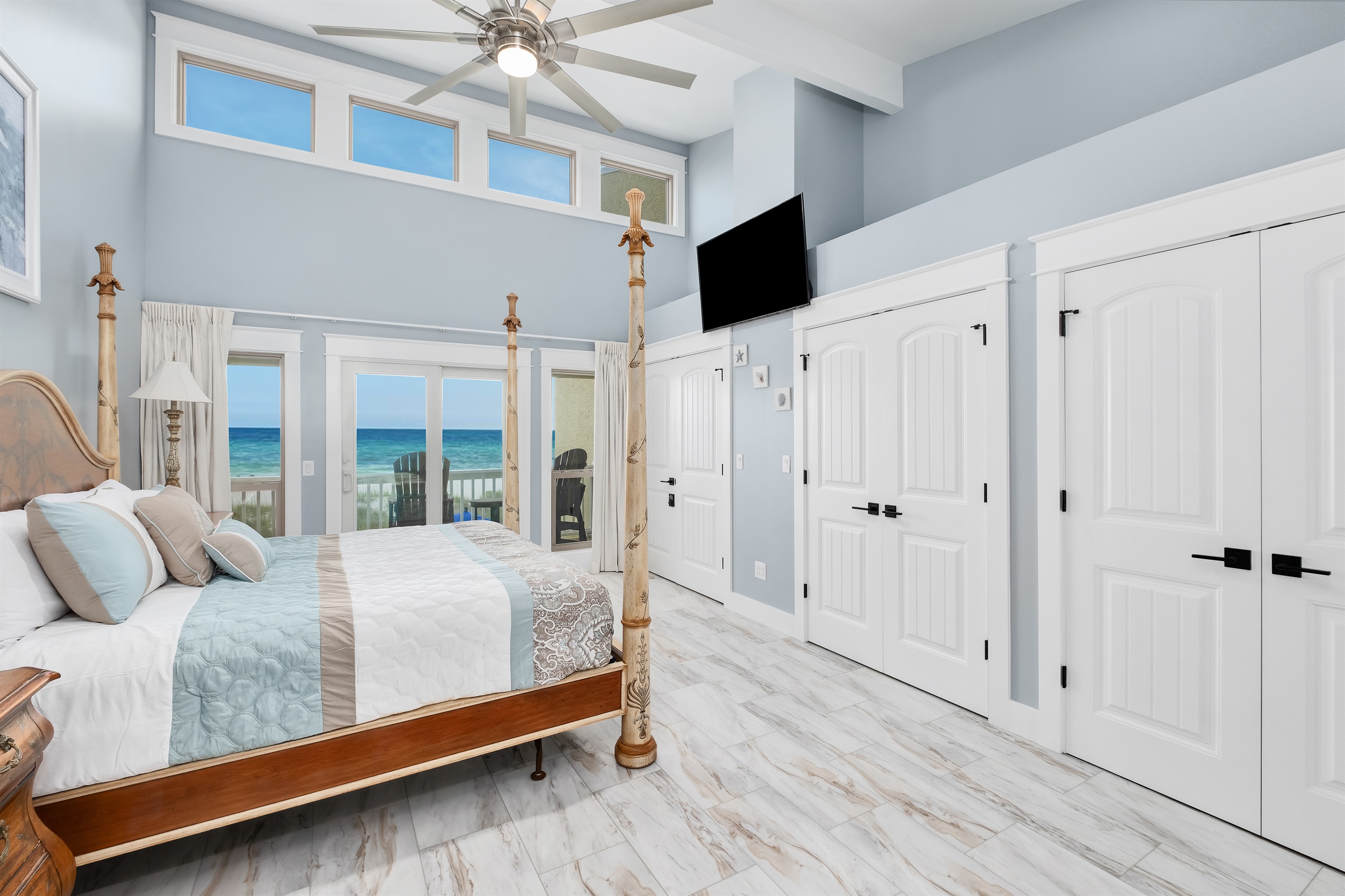Wake up to the sound of waves in this luxurious master bedroom with panoramic ocean views and a private balcony.