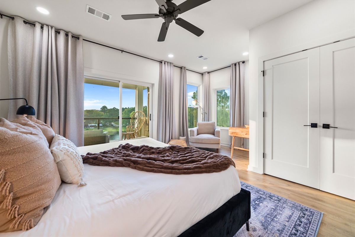 Bedroom with private balcony access and modern furnishings.