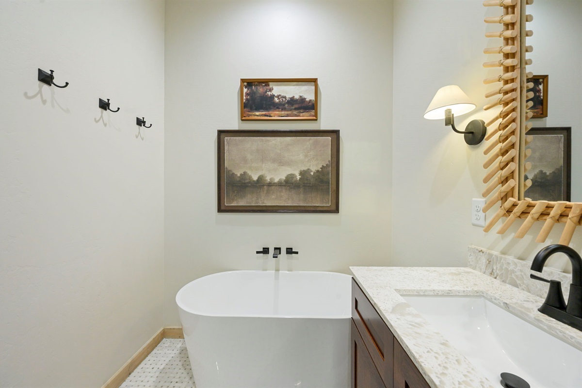 Beautiful wood vanity with statement mirror and plenty of counter space.
