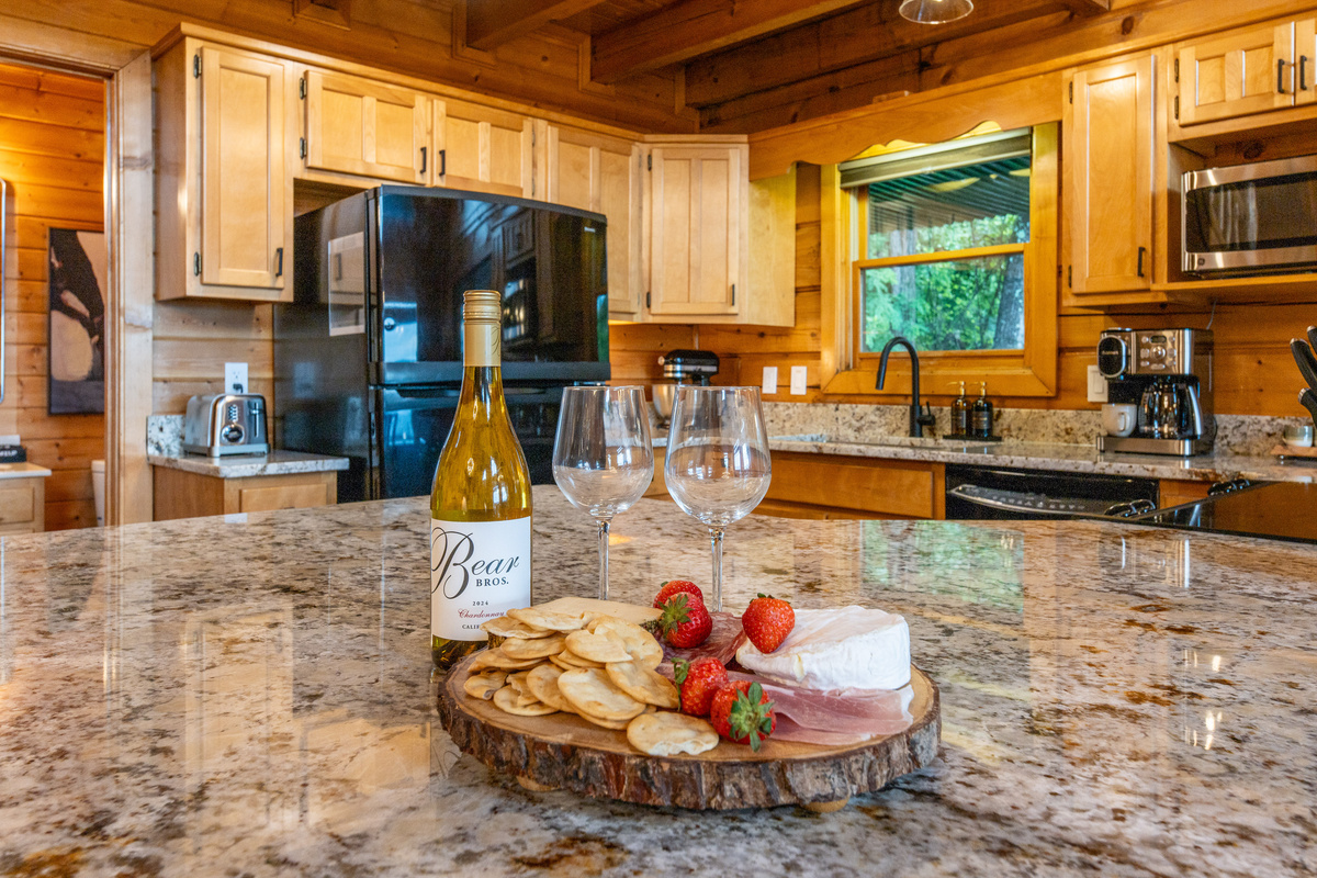 Large granite countertops in the open concept kitchen give guests a hangout space while cooking or dining.