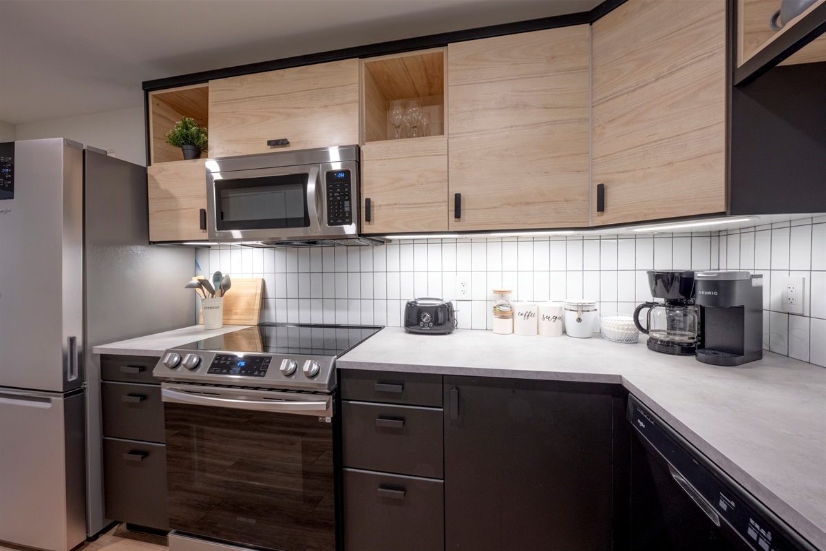 Modern kitchen with dishwasher, microwave, and full-size appliances.