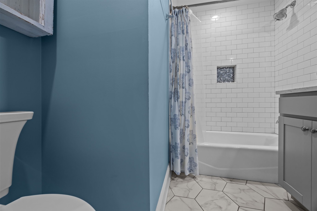 Family-friendly bathroom with a versatile shower and tub combo