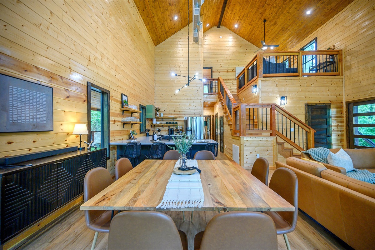 Gather around the farmhouse-style dining table in this beautifully designed open space, perfect for sharing meals and making memories. Table seats 8 bar top seats 4.