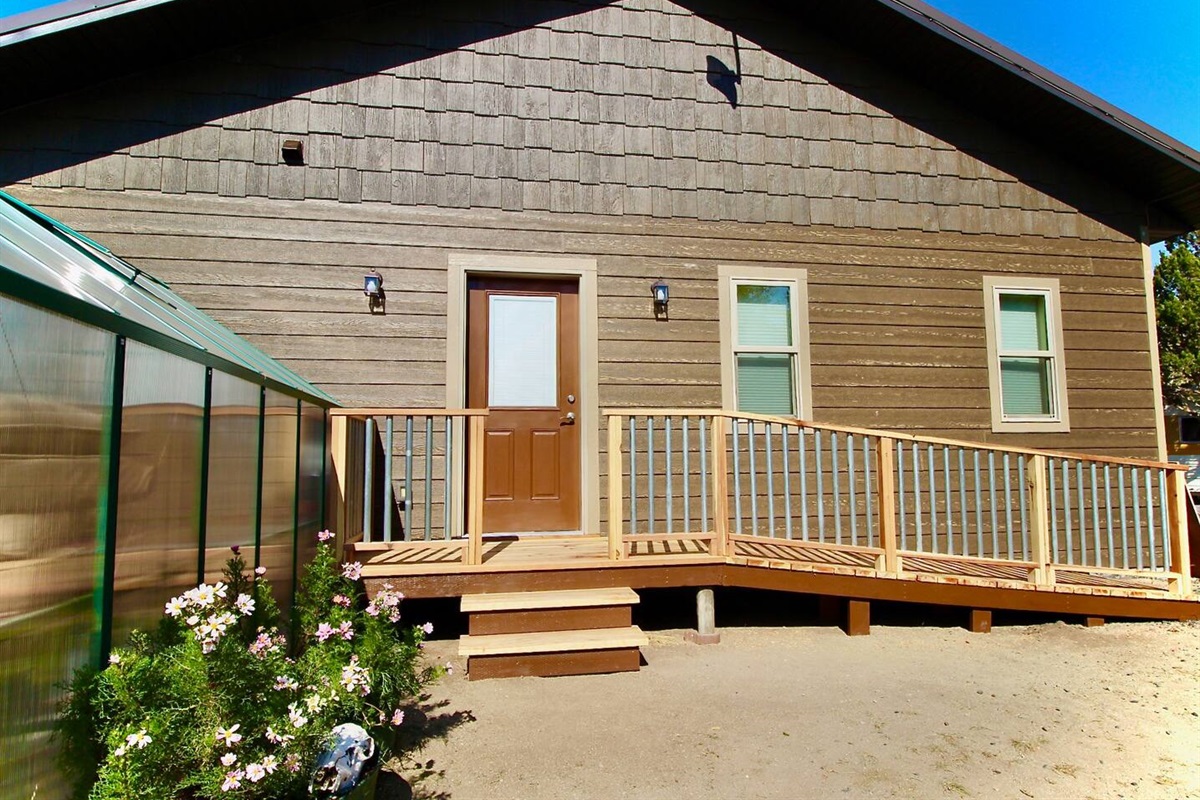 Enjoy your morning coffee on the deck, framed by flower planters and 100 acres of peaceful Montana views.