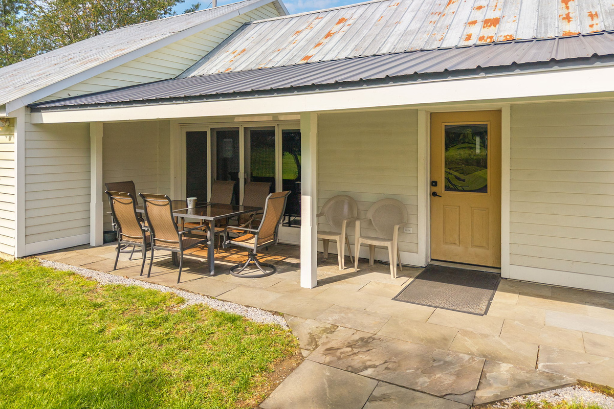 Sliding glass doors connect the indoor dining area to the covered patio.