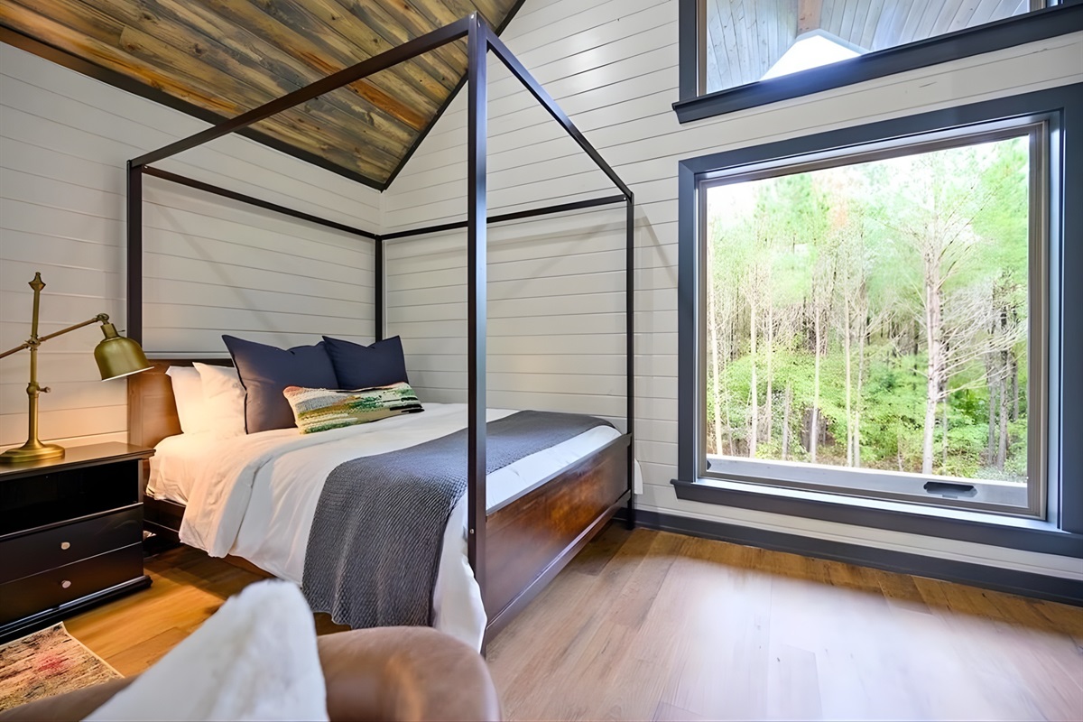 Waking up in the loft feels extra special thanks to the large windows that frame peaceful views of the trees.