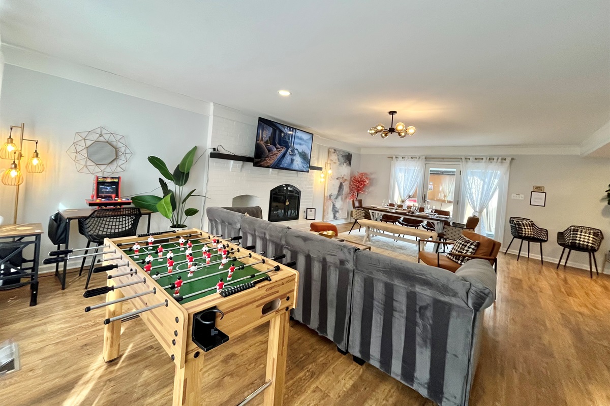 Spacious family room with fireplace and games and large patio door open door outdoor