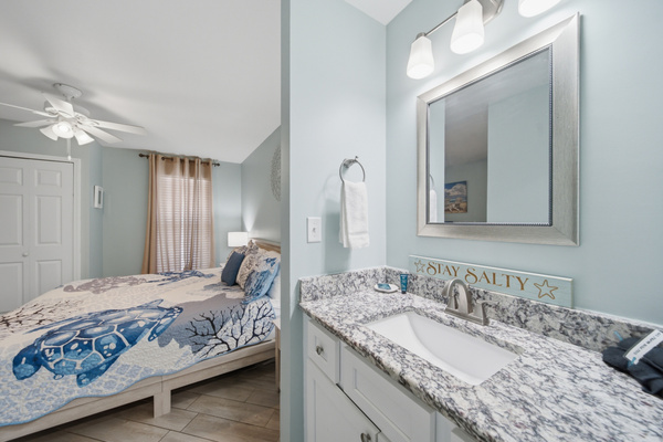 Primary bedroom opens directly to its ensuite vanity