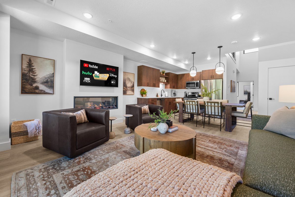 The open-concept living space, complete with a dining area, facilitates effortless conversation with family and friends.