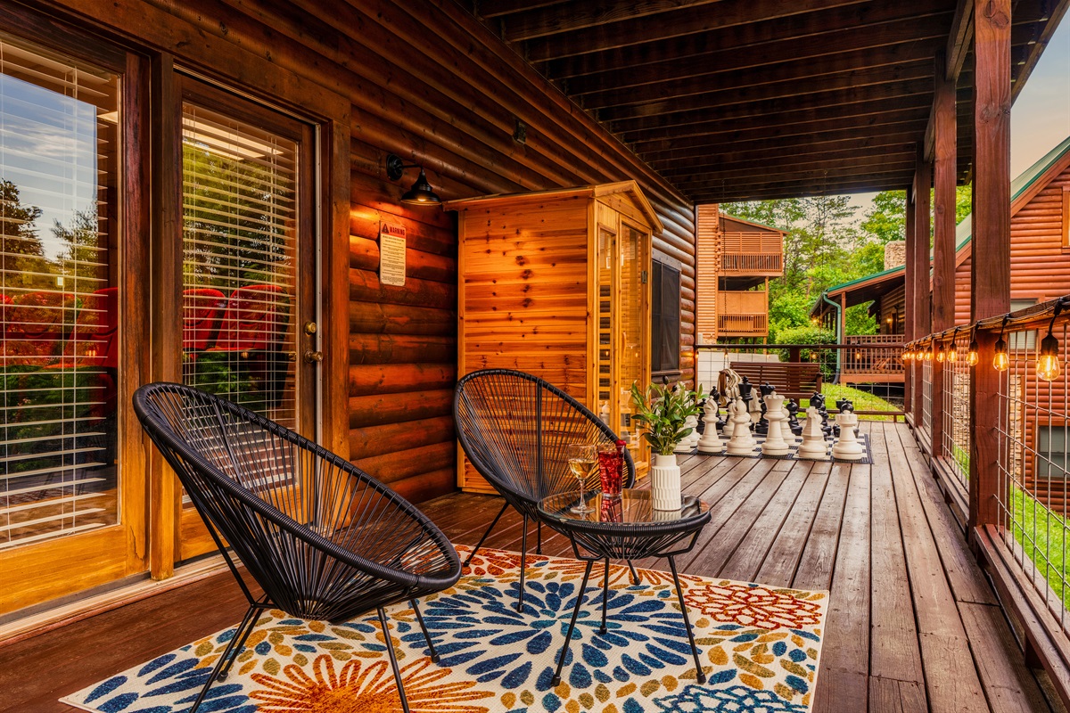 Our lower level porch features seating, sauna, and giant chess for relaxation and fun.