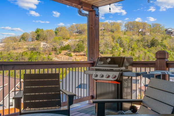 Weber propane grill with large prep station.