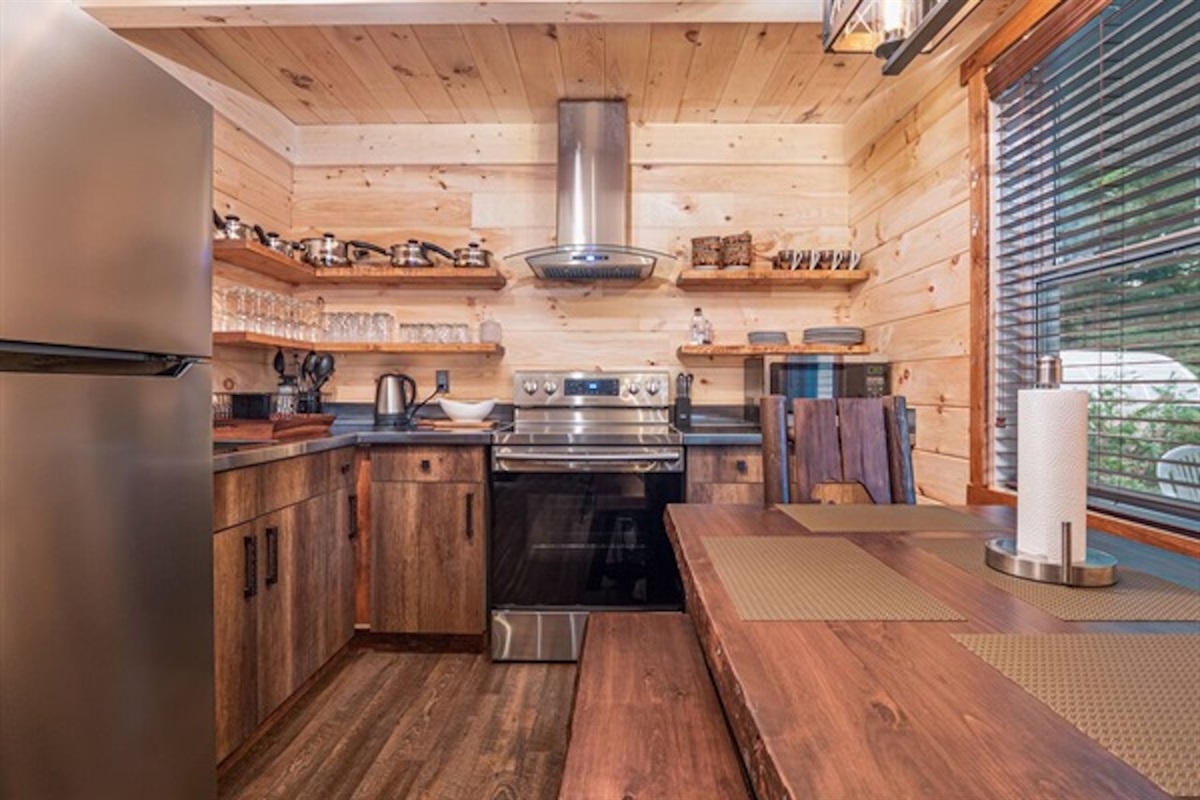 Fully equipped kitchen with rustic cabinetry and modern appliances