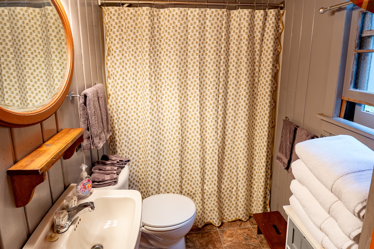 Comfortable Bathroom with charming shower tub. Shampoo, conditioner, and body wash provided