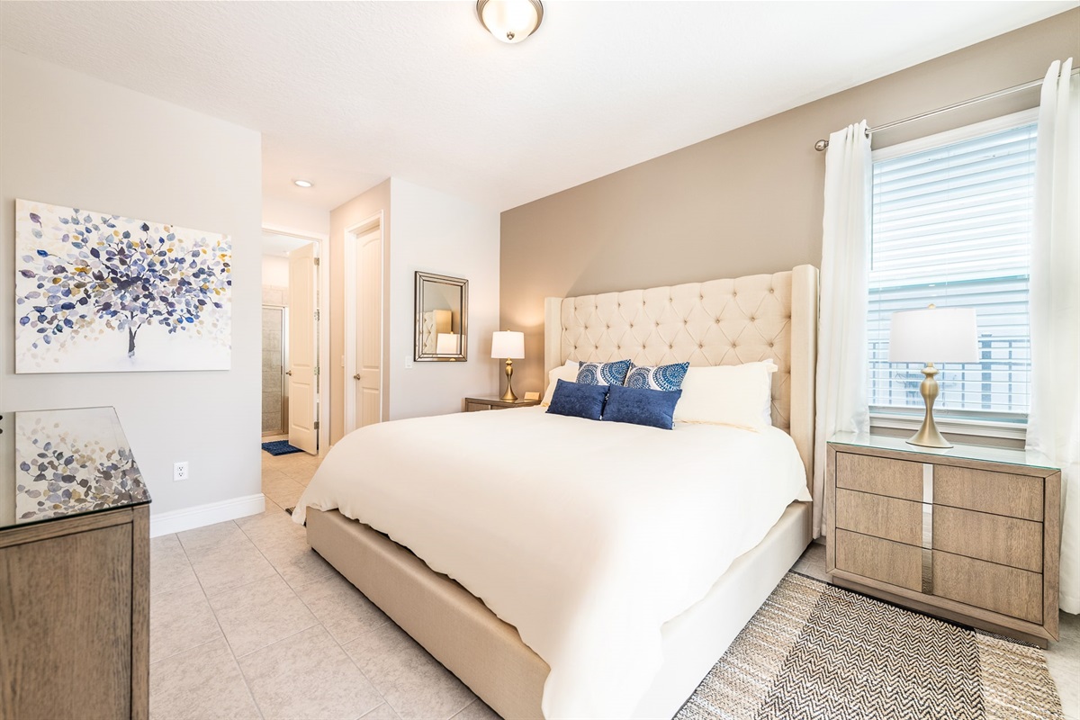 Unwind in the luxurious king-size master bedroom, designed for ultimate comfort and relaxation.