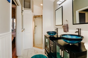 A bathroom designed with a chic combination of blue, black, and white tones, creating a sleek and contemporary space for relaxation and rejuvenation.