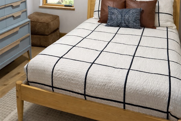 Second-floor full bed with clean, modern styling