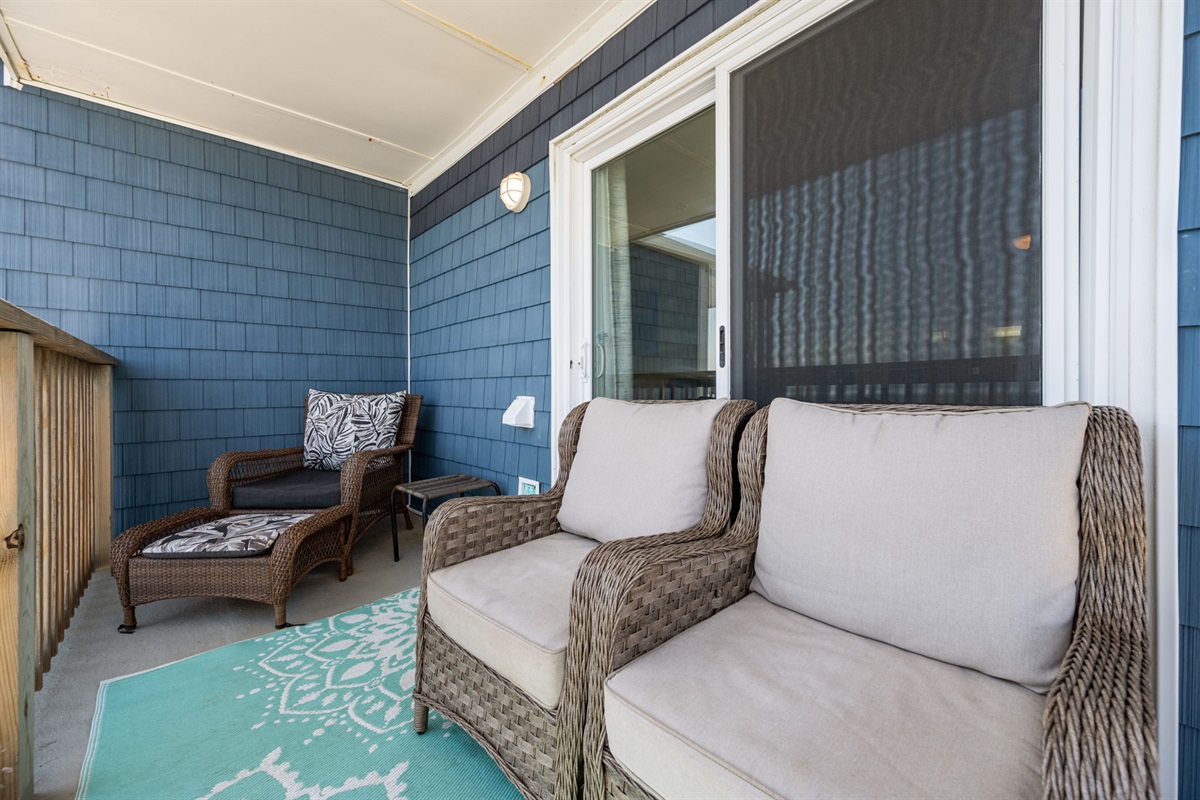 Private balcony with comfortable seating, a perfect spot to unwind and enjoy the coastal breeze