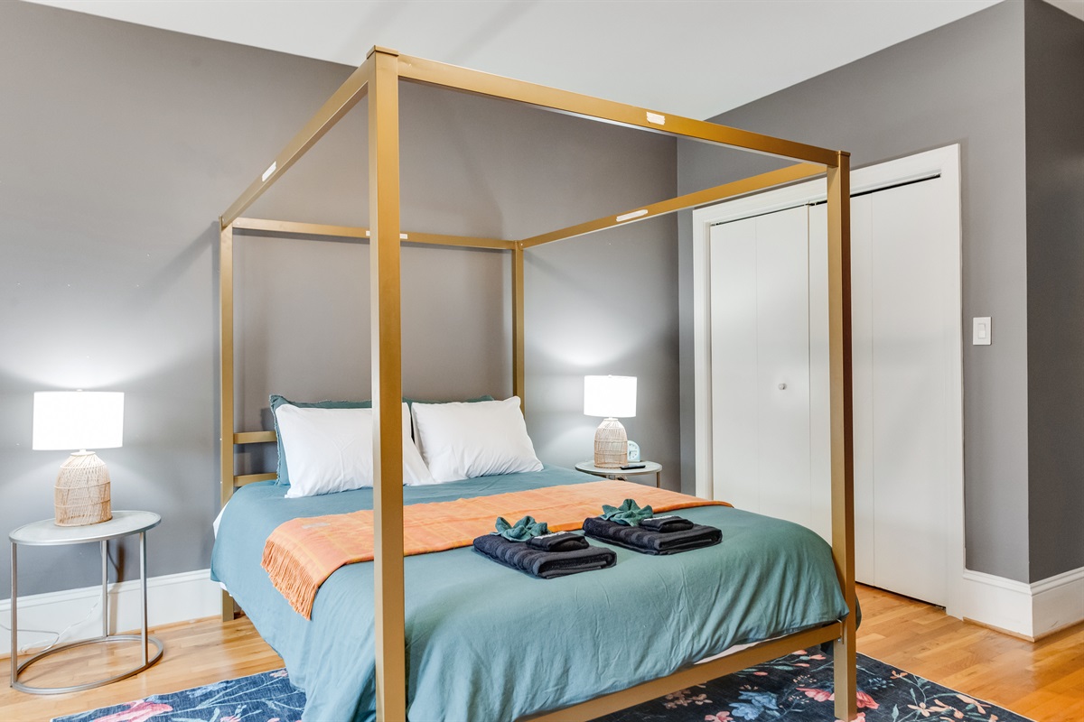 Queen Bedroom 2: Enjoy luxury in this chic four-poster bed with stylish decor and soft lighting!